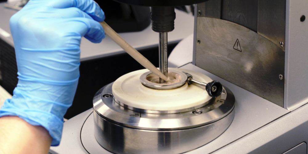 sample being loaded into rheometer instrument